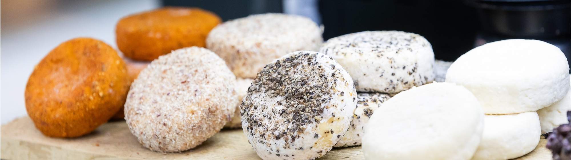 Selection of cow, goat, and sheep milk cheeses displayed on a tasting board, illustrating the diversity of French cheese production.