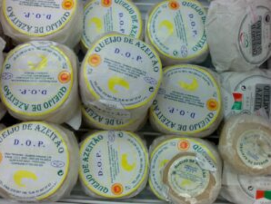 Stack of Portuguese Azeitão DOP cheeses, individually wrapped with a yellow and blue label.