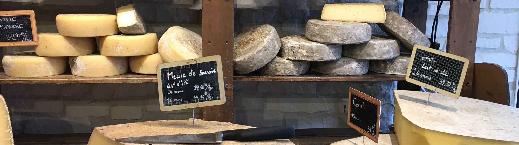 Plenty of cheeses in a cheese shop. 
