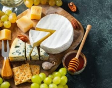 A cheese platter with honey