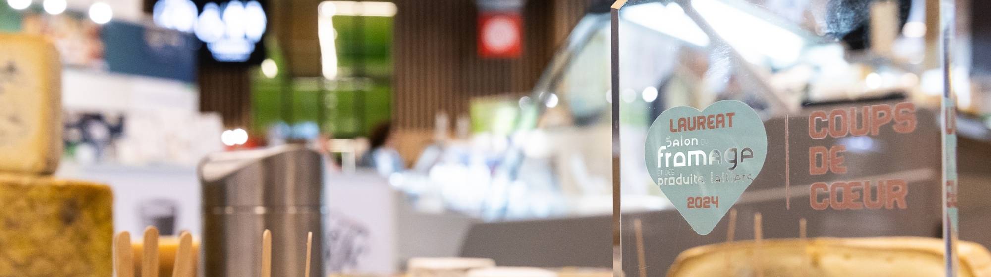 Close-up of the 'Coup de Cœur' award trophy at the 2024 Cheese Salon.