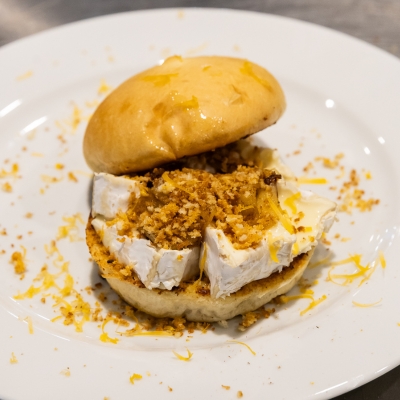 A sandwich with goat cheese and crumbled biscuits.