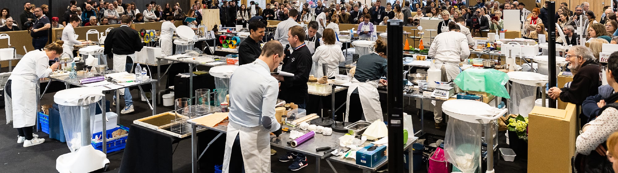 Picture of the contest with all the participants working on their cheese platter. 